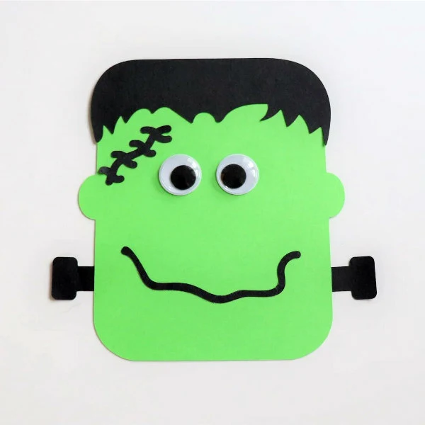 green and black Frankenstein paper craft with google eyes and screw in neck