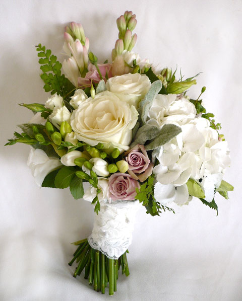 The bouquet consists of open avalanche roses ivory something special 
