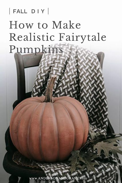 large Cinderella pumpkin on wooden chair with fall throw