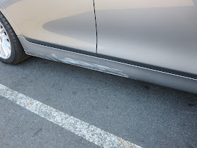 BMW with deep paint scratches on rocker panel before repairs at Almost Everything Auto Body