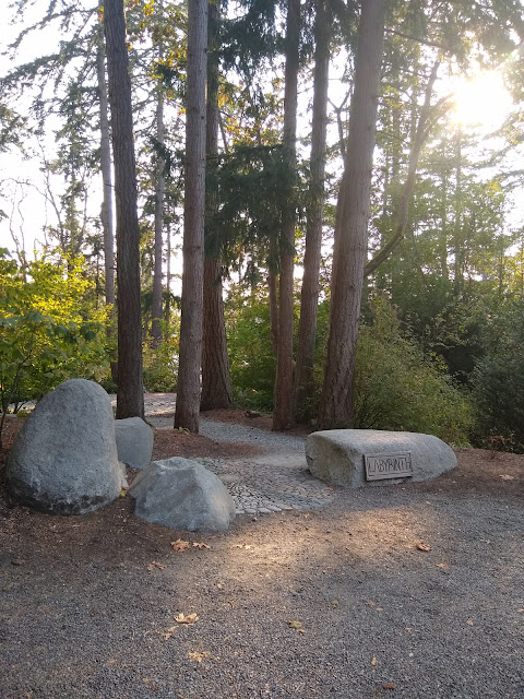 Trees, a circle of rocks, and a sign reading LABYRINTH