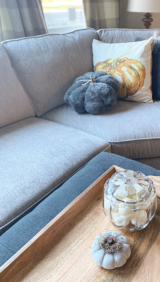 neutral sofa with pumpkin pillows