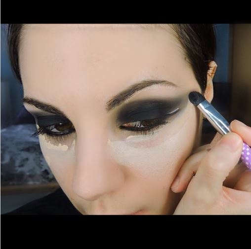 Ultima Beauty applying concealer under the eyes
