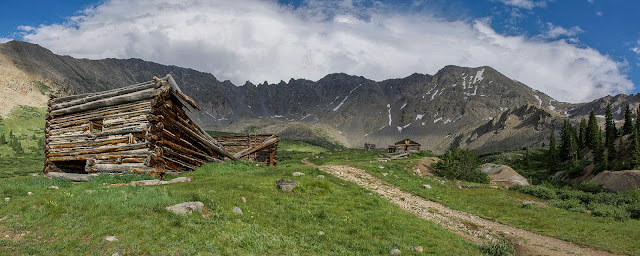 Old mining cabins in Mayflower Gulch with Atlantic Peak and Fletcher Mountain