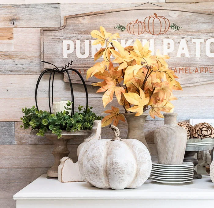 Wood wall, white dresser with farmhouse pumpkins and Fall decor