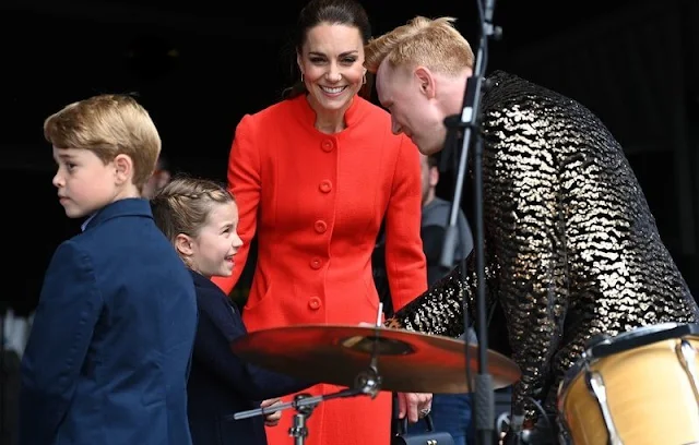 Kate Middleton wore a long red coat. Princess Charlotte wore a navy frock coat by AmaiaKids Razorbil and blue Mary Jane shoes