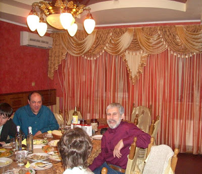  party, just by the door of this red room, enjoys music and dances