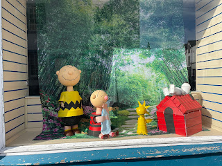 Charlie Brown flower put sculpture with Snoopie and Linus.