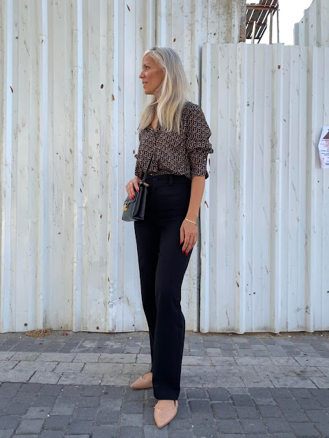 woman against white corrugated metal fence