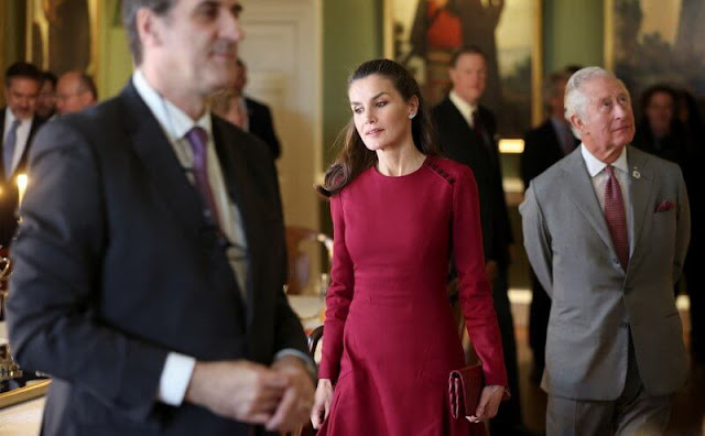 Queen Letizia wore a black wool and cashmere blend coat, and a new red midi dress by Carolina Herrera. The Prince of Wales