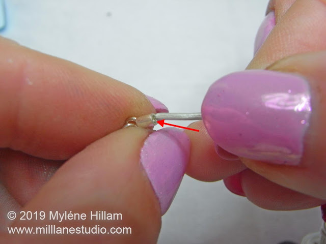 Inserting the bracelet ends intio the cord ends to finish the bracelet.