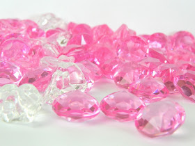 A handful of pink plastic gems, from a Japanese arcade machine