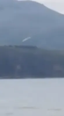 A white-ish Flying Saucer that takes off from over the sea and beach in Sicily in Italy, 2017.