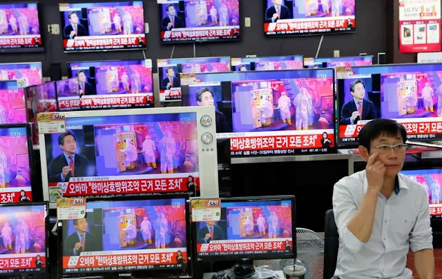 Image Attribute: A sales assistant sits next to TV sets broadcasting a news report on North Korea's fifth nuclear test, in Seoul, South Korea, September 9, 2016.  REUTERS/Kim Hong-Ji