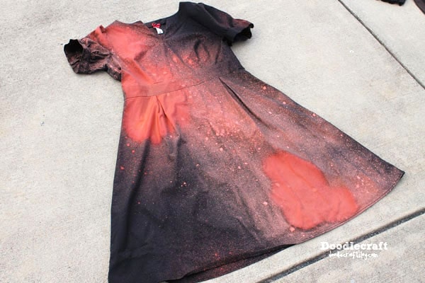 I armed myself with the spray bottle of bleach!    I sprayed strategically in a diagonal line down the dress. Leave some of the dress black.   Instantly the dress bleached!    Turning a horrifying shade of coral!!! Is this a mistake???   Then I turned the dress over and bleached the backside in the same place as the front.