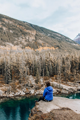 An image of a lonely woman hiker sitting on a mountain