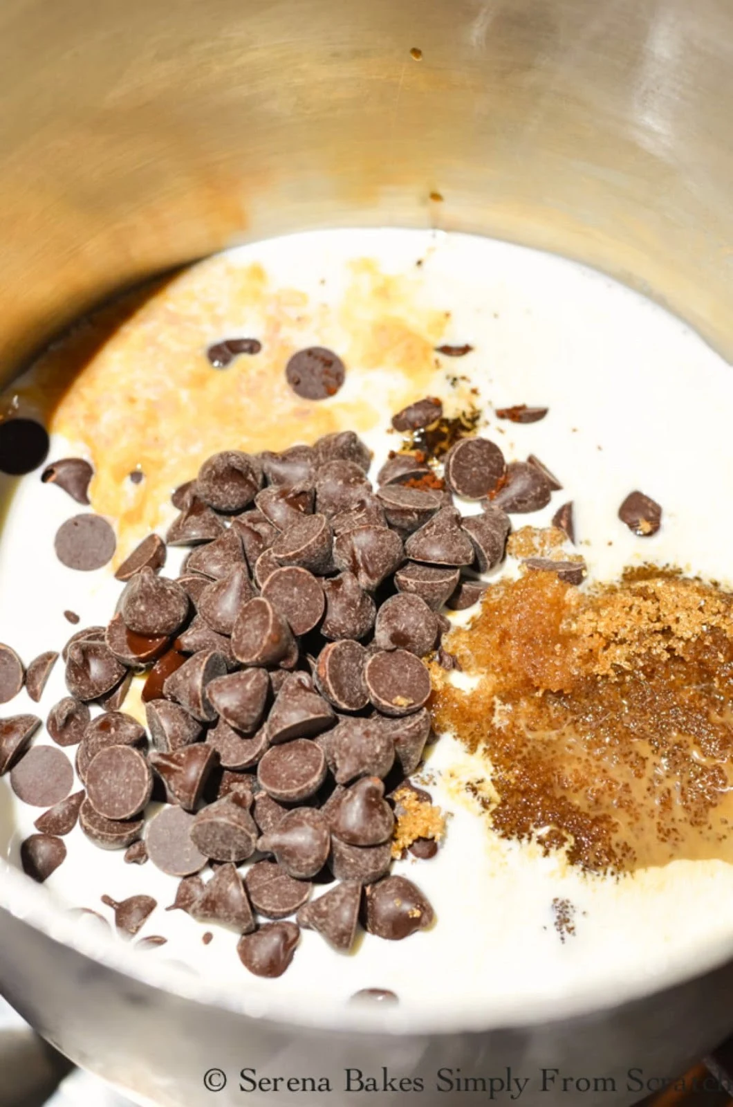 A small saucepan with chocolate chips, half and half, brown sugar, instant coffee, vanilla and salt.