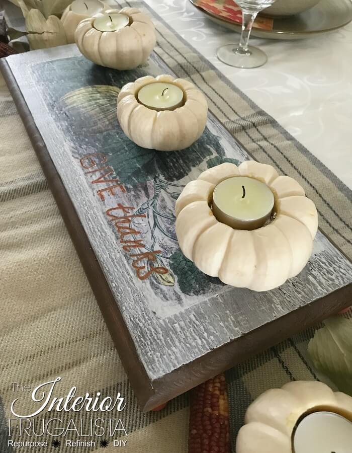 A simple wood table riser with farmhouse-style made with scrap wood and a vintage pumpkin graphic for Fall decor. Without feet it's a cute Fall sign!