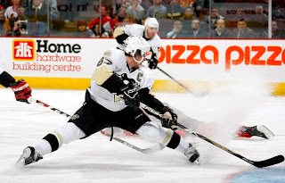 KANATA, CANADA - APRIL 14: Sidney Crosby #87 of the Pittsburgh Penguins stretches to receive a pass from teammate Pascal Dupuis #9 while facing the Ottawa Senators during game three of the 2008 NHL Eastern Conference Quarterfinals on April 14, 2008 at Scotia Bank Place in Kanata, Ontario, Canada. (Photo by Dave Sandford/Getty Images)<br />