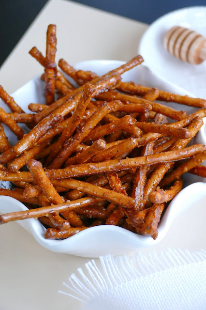 pretzels in a white bowl with a tan background.