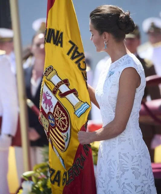 Queen Letizia wore a white lace sleeveless midi dress. Genuine aquamarine earrings by Bvlgari jewellery. Magrit pumps and clutch