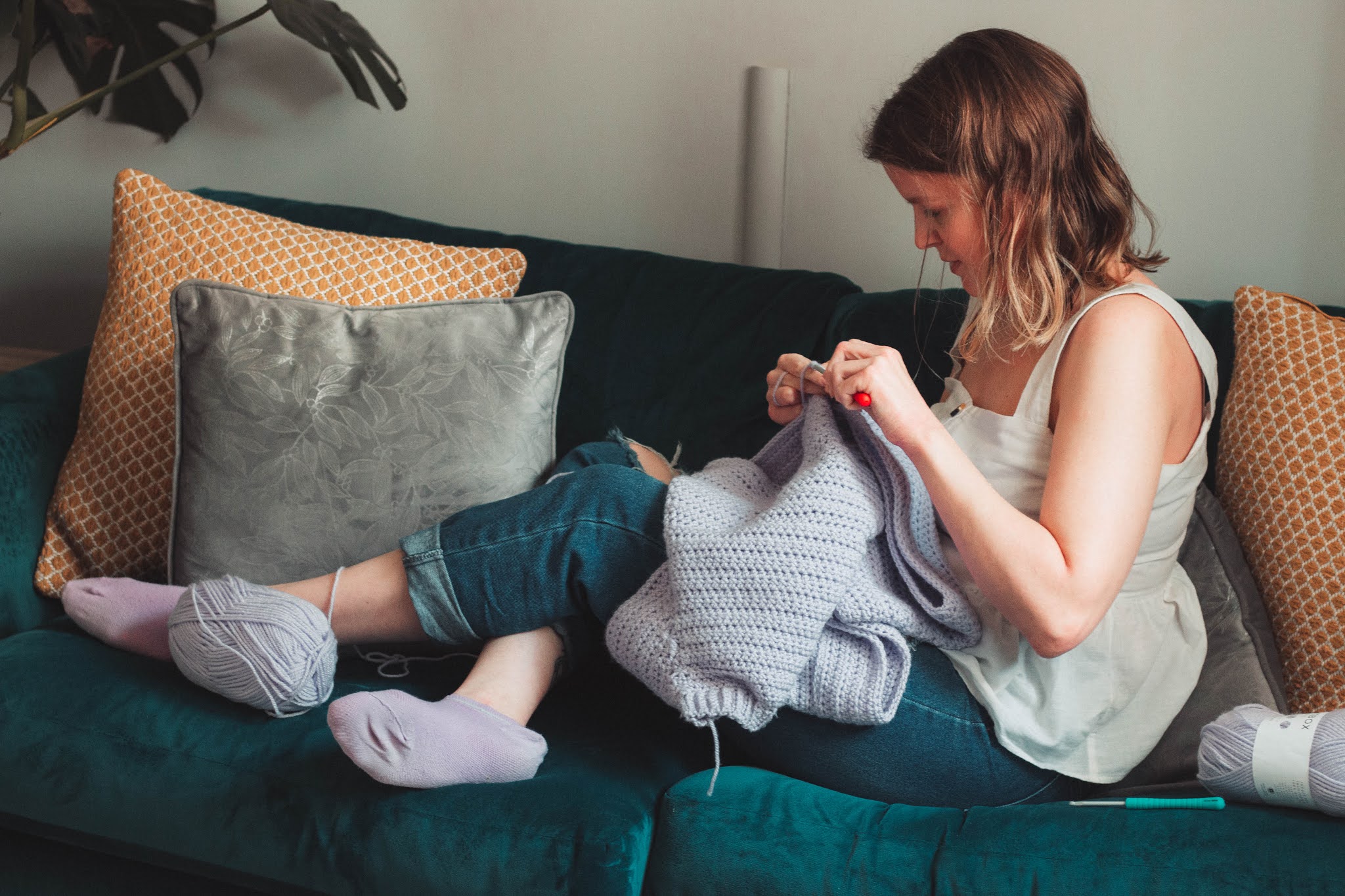 girl crocheting lilac jumper - 5 creative hobbies for self care blog post