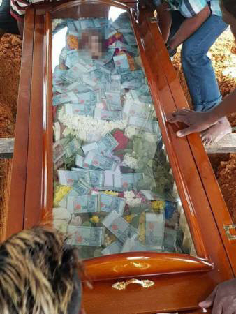 Photos: Man buries his father with US$7,630 in cash filled inside glass-topped coffin