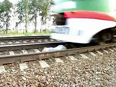 Girl lies under Running train