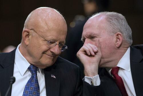 Director of National Intelligence James Clapper (L) and CIA Director John Brennan chat before testifying before the Senate Intelligence Committee on Feb. 9, 2016.