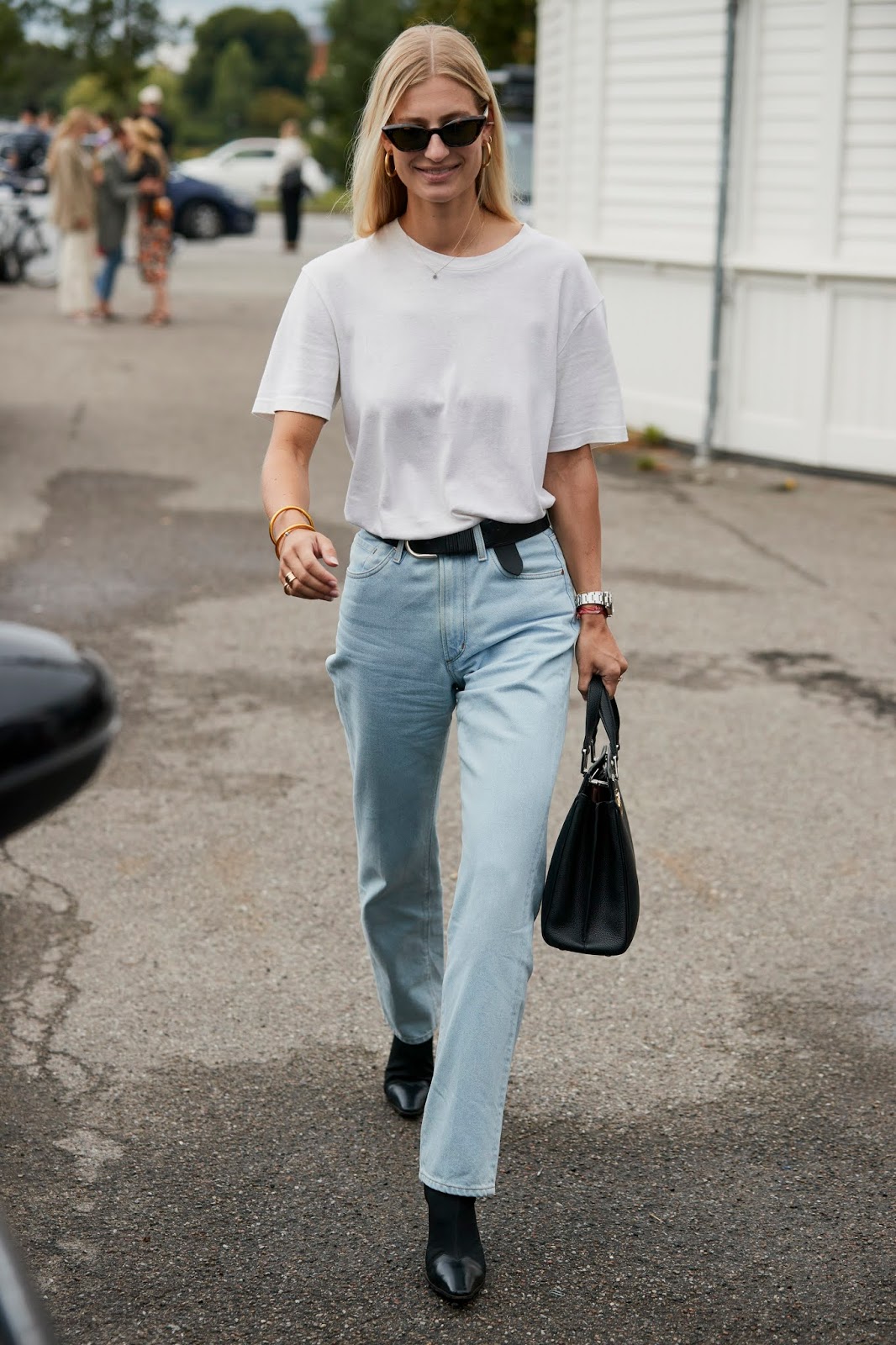 25 Best White Shirts for Spring Summer Outfits — Street Style Outfit Inspiration with cat-eye sunglasses, a white tee, belted straight-leg jeans, and black boots