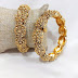 Broad golden bangles
