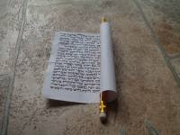 Roll the scroll tightly around a pencil or a pen.