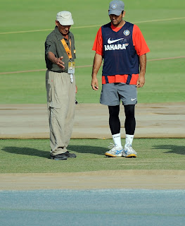 Indian skipper Dhoni and curator inspect the Mohali pitch