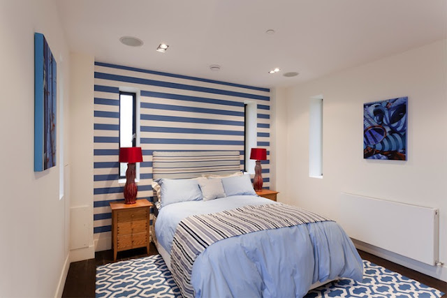 Picture of another modern bedroom with blue and white wall
