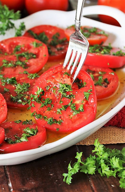 Serving Marinated Tomatoes With a Fork Image