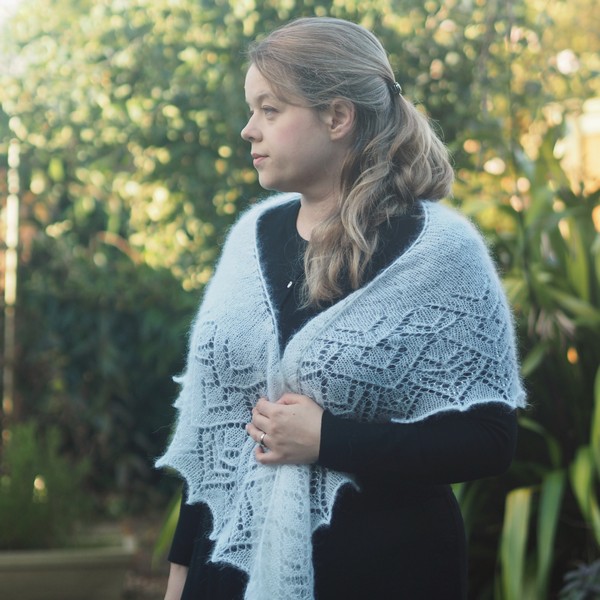 white mohair lace shawl worn in a traditional way around the shoulders