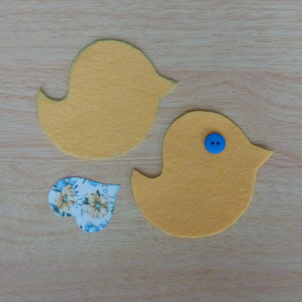 Two bird pattern pieces fabric wing and blue button