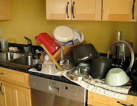 dishes drying in a rack and on towels placed on the countertop