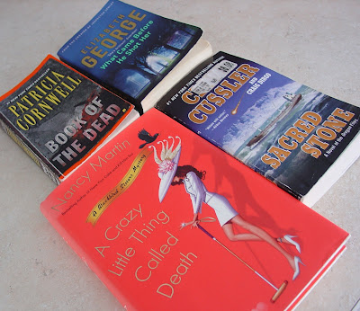 4 books that Vicky has recently read:  A Crazy Little Thing Called Death by Nancy Martin, Sacred Stone by Clive Cussler, Book of the Dead by Patricia Cornwell, and What Came Before He Shot Her by Elizabeth George