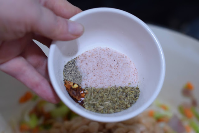 All of spices needed to make the soup being added to the pot.