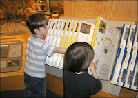 Galen & Liam looking through the sheets about local plants and wildlife