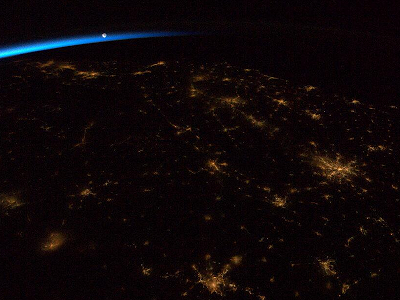 The Moon rising above Earth at night