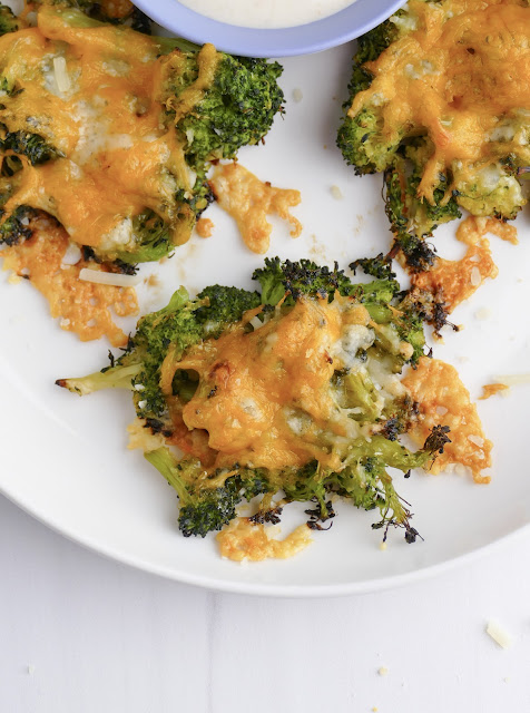 overhead shot of broccoli bites on a white plate.