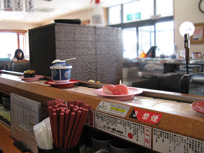 Fast Food Sushi on Sushi Plates Are Placed On A Rotating Conveyor Belt That