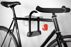 metal wall-mounted bike rack - accommodates a lock