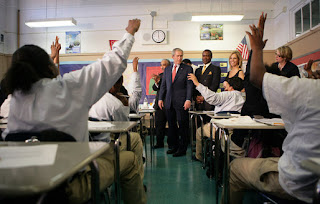 Students in the seventh grade science class at Harlem Village Academy Charter School in New York, raise their hands to answer a question posed by President George W. Bush during his visit to the school Tuesday, April 24, 2007. White House photo by Eric Draper.