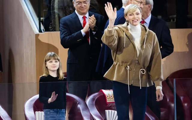 Princess Charlene wore a double face hooded jacket by Louis Vuitton. Loro Piana white cashmere turtleneck sweater