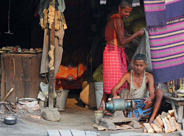 knife sharpener working in his hut