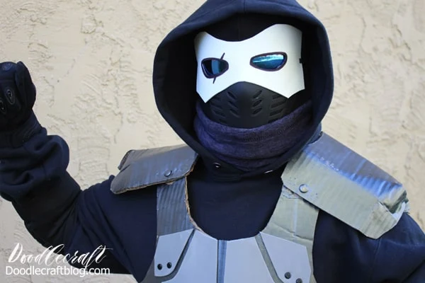 Make the perfect Halloween Fortnite Cosplay. The Enforcer Skin Costume DIY is easy to make with items found in the closet, upcycled items like cardboard, foam and brads and a boogie bomb.