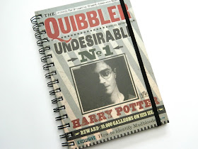 A photo of a Harry Potter notebook featuring a newspaper design from the movies